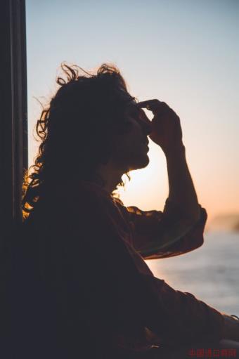 silhouette of woman holding her forehead from headache