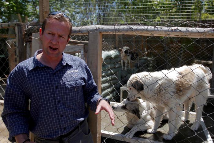 Pen Farthing, founder of British charity Nowzad, an animal shelter, stands in front of a cage on the outskirts of Kabul May 1, 2012. REUTERS/Omar Sobhani (AFGHANISTAN - Tags: ANIMALS SOCIETY)/File Photo