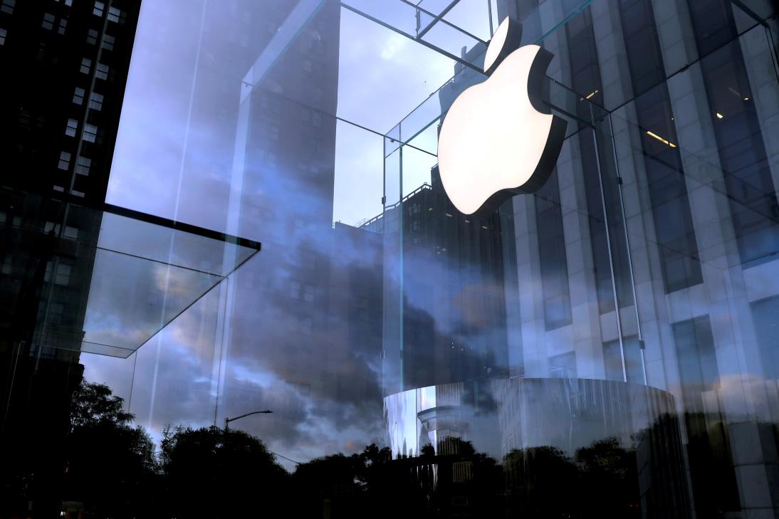 The Apple Inc. logo is seen hanging at the entrance to the Apple store on 5th Avenue in Manhattan, New York, U.S., October 16, 2019. REUTERS/Mike Segar/File Photo