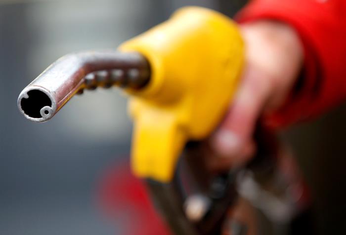 A petrol station attendant prepares to refuel a car in Rome, Italy, January 4, 2012. REUTERS/Max Rossi