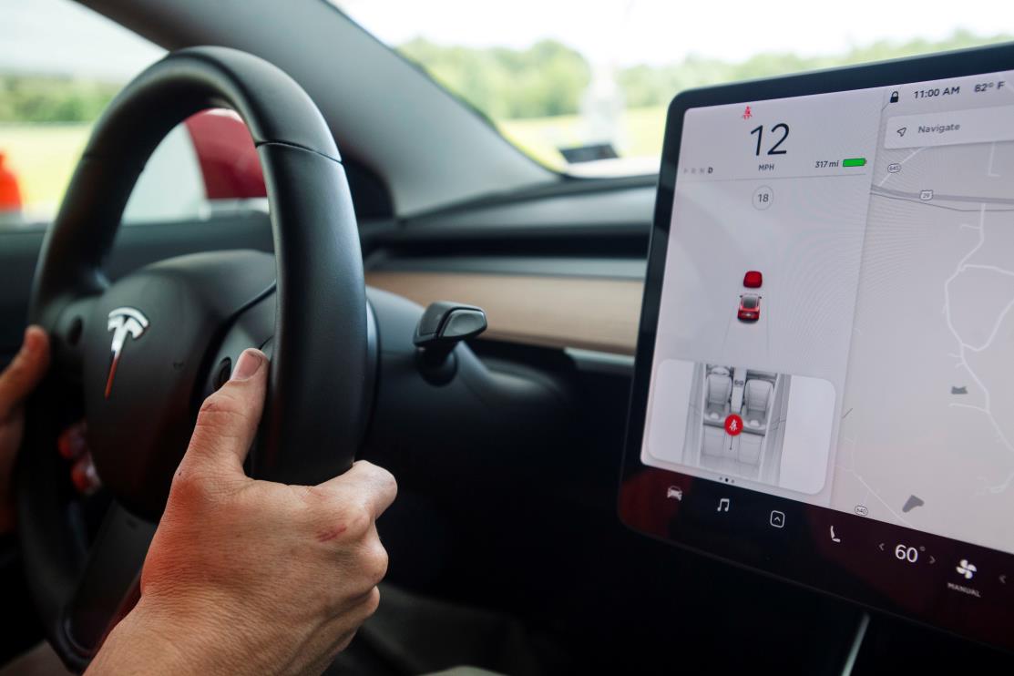 Joe Young, media relations associate for the Insurance Institute for Highway Safety (IIHS), demo<em></em>nstrates a front crash prevention test on a 2018 Tesla Model 3 at the IIHS-HLDI Vehicle Research Center in Ruckersville, Virginia, U.S., July 22, 2019.  REUTERS/Amanda Voisard/File Photo