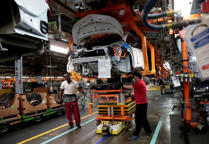 General Motors assembly workers co<em></em>nnect a battery pack underneath a partially assembled 2018 Chevrolet Bolt EV vehicle on the assembly line at Orion Assembly in Lake Orion, Michigan, U.S., March 19, 2018.   REUTERS/Rebecca Cook/File Photo