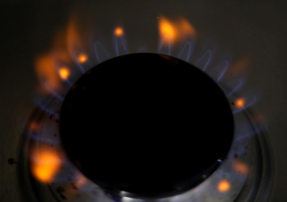 Flames come out of a domestic gas ring on a stove in Manchester, Britain, September 18, 2021. REUTERS/Phil Noble