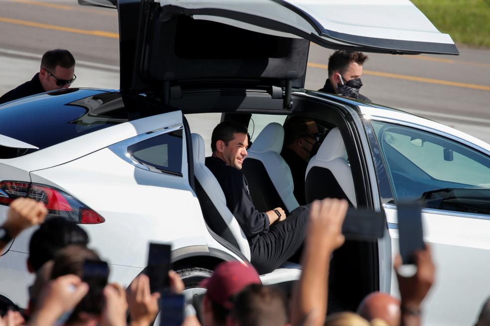 Jared Isaacman, founder and CEO of Shift4 Payments and flight commander, climbs into a Tesla as the Inspiration 4 crew, the first all-civilian crew to be sent into orbit, gather before dawning space suits to head to the SpaceX Falcon 9 rocket on Pad 39A at the Kennedy Space Center in Cape Canaveral, Florida, U.S., September 15, 2021.  REUTERS/Joe Skipper/File Photo