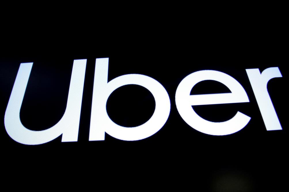 A screen displays the company logo of Uber Technologies Inc on the day of its IPO at the New York Stock Exchange (NYSE) in New York, U.S., May 10, 2019. REUTERS/Brendan McDermid