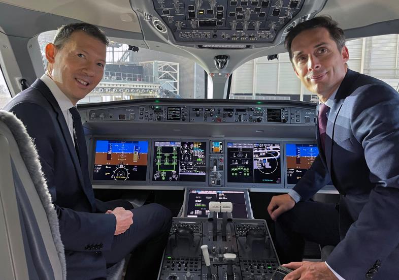 Benjamin Smith, Chief Executive Officer of Air France-KLM, and French Junior Transport Minister Jean-Baptiste Djebbari, pose inside the cockpit of the first Air France airliner's Airbus A220 during a ceremony in the Air France hangar at Paris Charles de Gaulle airport in Roissy near Paris, France, September 29, 2021. REUTERS/Antony Paone