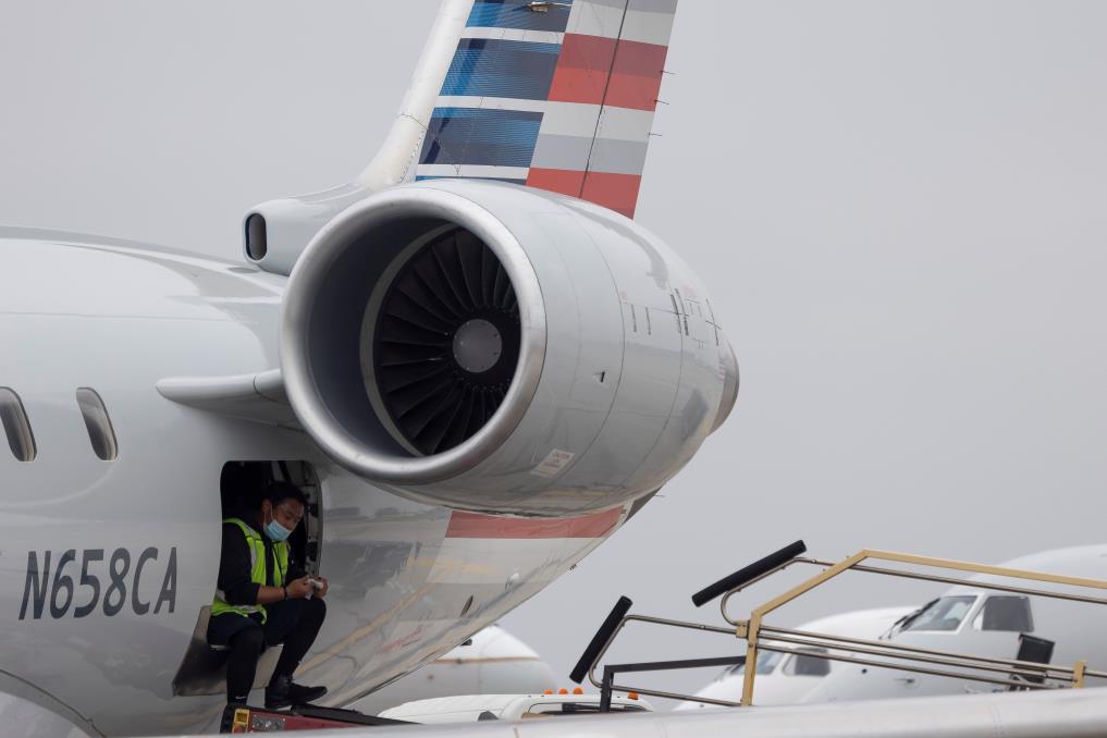 Passengers wait to board a flight as more than 1,400 American Airlines flights over the weekend have been canceled due to staff shortages and unfavorable weather in  San Francisco, California, U.S., October 31, 2021. REUTERS/Carlos Barria