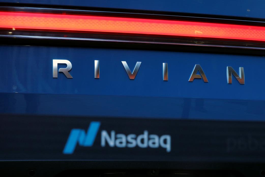 The company logo is seen on a Rivian R1T pickup, the Amazon-backed electric vehicle (EV) maker, as it is parked outside the Nasdaq Market site during the company’s IPO in Times Square in New York City, U.S., November 10, 2021. REUTERS/Brendan McDermid