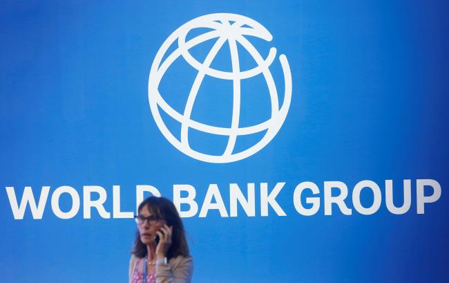 A participant stands near a logo of World Bank at the Internatio<em></em>nal Mo<em></em>netary Fund - World Bank Annual Meeting 2018 in Nusa Dua, Bali, Indonesia, October 12, 2018. REUTERS/Johannes P. Christo/File Photo