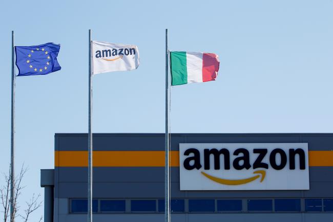 Flags flutter outside a distribution centre, during a strike at Amazon's logistics operations in Italy, in Passo Corese, Italy March 22, 2021. REUTERS/Remo Casilli