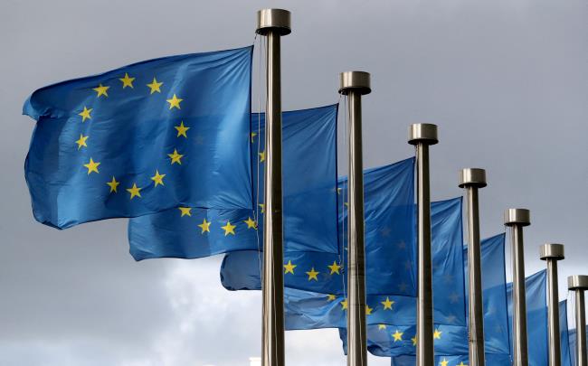 EU flags flutter in front of the European Commission headquarters in Brussels, Belgium October 2, 2019. REUTERS/Yves Herman//File Photo