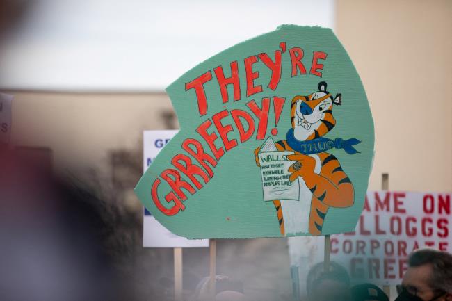 A sign is held up in the crowd as U.S. Senator Bernie Sanders (I-VT) speaks and expresses his support for striking Kellogg workers from the Porter Street plant at the Battle Creek Farmers Market in Battle Creek, Michigan, U.S., December 17, 2021. REUTERS/Emily Elconin