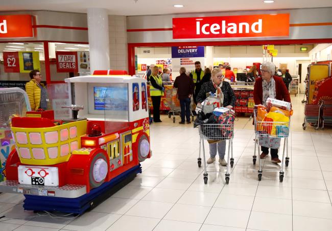 People with their shopping as they leave an Iceland store in the Kennedy Centre. REUTERS/Jason Cairnduff