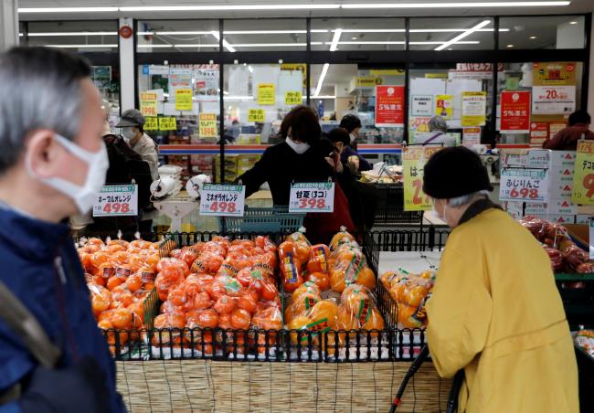 Shoppers wearing protective face masks, following an outbreak of the coro<em></em>navirus disease (COVID-19), are seen at a supermarket in Tokyo, Japan March 27, 2020.    REUTERS/Issei Kato/File Photo  GLOBAL BUSINESS WEEK AHEAD