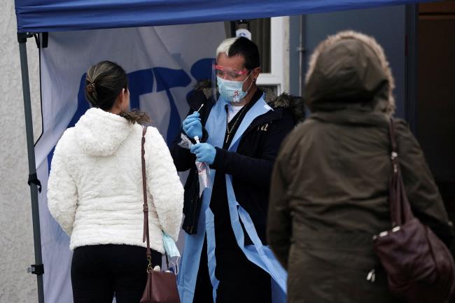 A healthcare worker collects a nasal swab sample at a coro<em></em>navirus disease (COVID-19) test site operated at Park Hills Community Church during the holiday season as the Omicron variant threatens to increase case numbers in View Park, California, U.S., December 22, 2021. REUTERS/Bing Guan