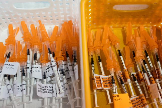 Syringes filled with the Pfizer BioTech coro<em></em>navirus disease (COVID-19) vaccine are seen at Sparrow Laboratories Drive-Thru Services in Lansing, Michigan, U.S., December 27, 2021. REUTERS/Emily Elconin