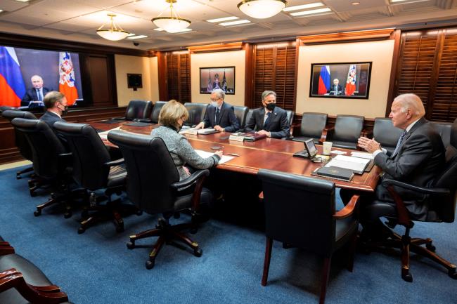 U.S. President Joe Biden holds virtual talks with Russia's President Vladimir Putin amid Western fears that Moscow plans to attack Ukraine, as Secretary of State Antony Bme<em></em>taen listens with other officials during a secure video call from the Situation Room at the White House in Washington, U.S., December 7, 2021. The White House/Handout via REUTERS 