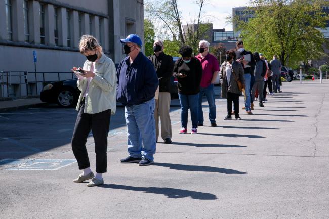 People line up outside a newly reopened career center for in-person appointments in Louisville, U.S., April 15, 2021.  REUTERS/Amira Karaoud