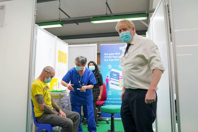 Britain's Prime Minister Boris Johnson looks on during a visit to a COVID-19 vaccination hub in the Guttman Centre at Stoke Mandeville Stadium in Aylesbury, Buckinghamshire, Britain January 3, 2022. Steve Parsons/Pool via REUTERS