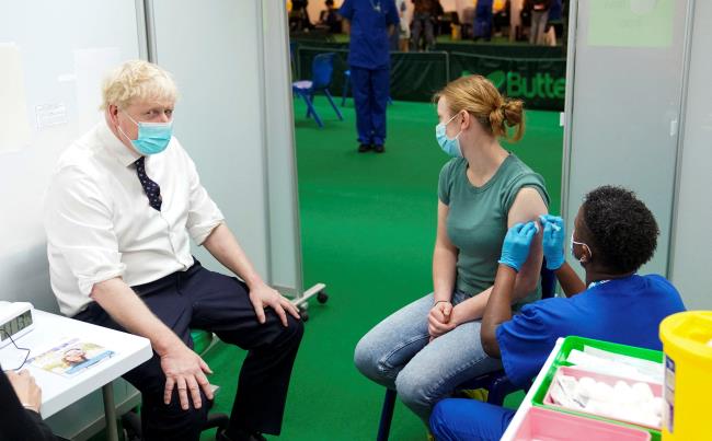 Britain's Prime Minister Boris Johnson looks on during a visit to a COVID-19 vaccination hub in the Guttman Centre at Stoke Mandeville Stadium in Aylesbury, Buckinghamshire, Britain January 3, 2022. Steve Parsons/Pool via REUTERS