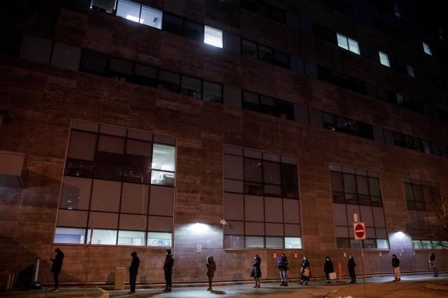 People queue up for their COVID-19 PCR test at Women's College Hospital, as the latest Omicron variant emerges as a threat, in Toronto, Ontario, Canada December 22, 2021. REUTERS/Cole Burston