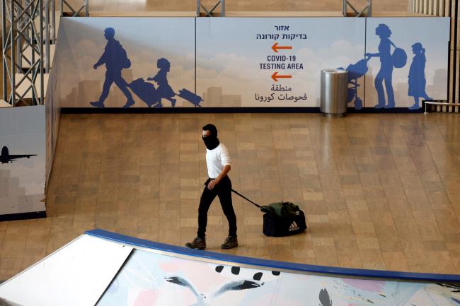 A traveler walks at Ben Gurion Internatio<em></em>nal Airport near Tel Aviv, Israel November 28, 2021. REUTERS/Amir Cohen