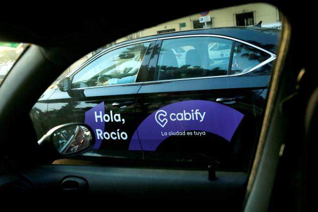 A Cabify taxi car is seen through the window of a car in Malaga, southern Spain August 3, 2018. REUTERS/Jon Nazca