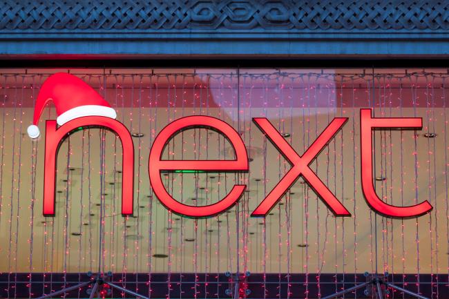 A Christmas themed logo of clothing retailer Next is seen at a store in London, Britain, December 2, 2021. REUTERS/May James