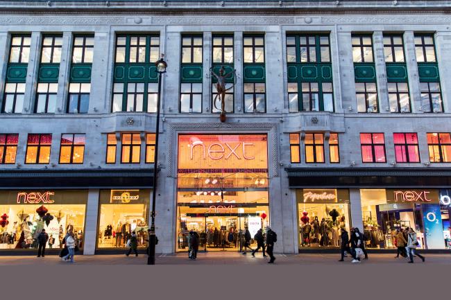 People walk past a store of clothing retailer Next, in London, Britain, December 2, 2021. Picture taken December 2, 2021.   REUTERS/May James