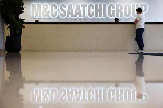 A person stands in the reception of the M&C Saatchi office in central London, Britain, January 6, 2022. REUTERS/Henry Nicholls