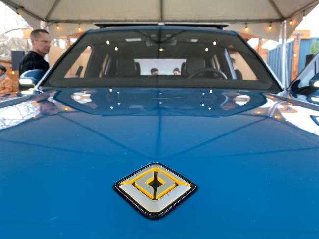 The logo for electric vehicle startup Rivian is seen on the hood of its new R1T all-electric truck in Mill Valley, California, U.S., January 25, 2020. REUTERS/Nathan Frandino/File Photo