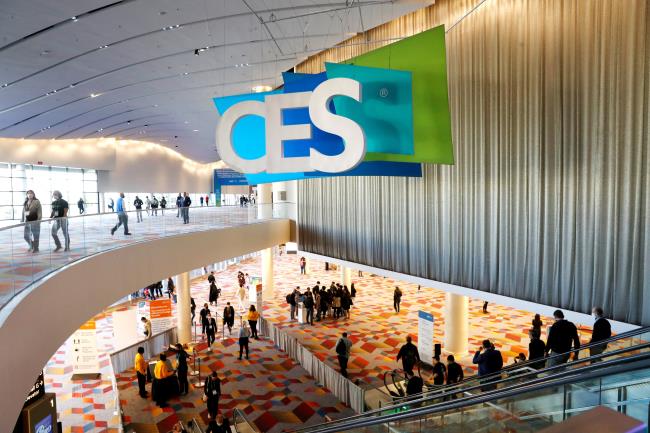 Attendees pass by a CES sign during CES 2022 in Las Vegas, Nevada, U.S. January 6, 2022. REUTERS/Steve Marcus