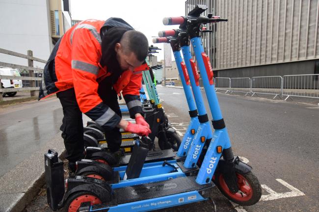 Zhelyo Kolev, a field technician at Dott, changes a swappable battery in one of the micromobility provider's electric scooters in London