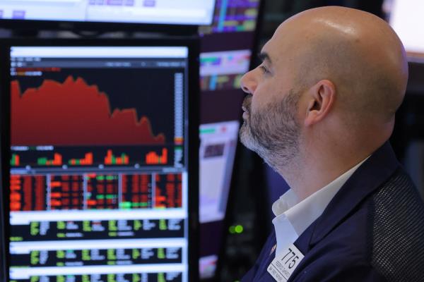 A trader works on the trading floor at the New York Stock Exchange (NYSE) in Manhattan, New York City