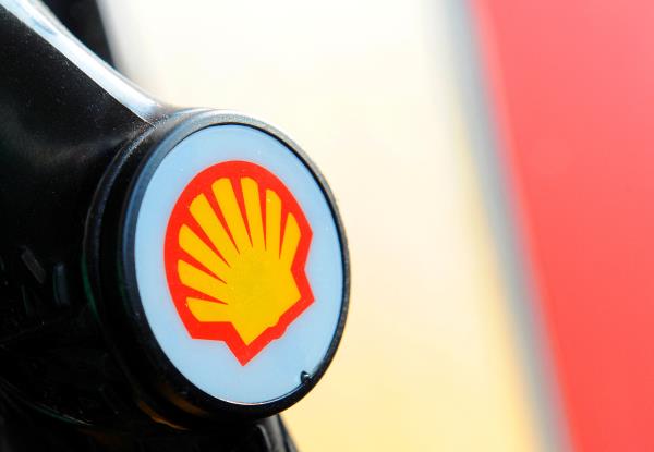 A Shell logo is seen on a pump at a petrol station in London