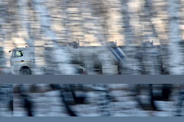 An oil tank truck drives along a road in Omsk