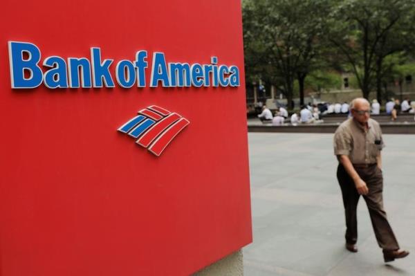 A man walks past a Bank of America sign in New York