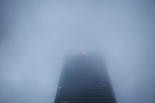 The logo on the building of HSBC's Lo<em></em>ndon headquarters appears through the early morning mist in London's Canary Wharf financial district