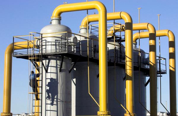 Worker climbs cylinder at gas compressor station at Yamal-Europe pipeline near Nesvizh