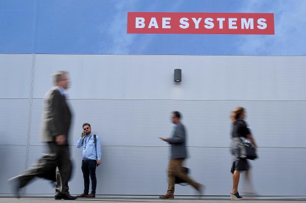 Trade visitors walk past an advertisement for BAE Systems at Farnborough Internatio<em></em>nal Airshow in Farnborough, Britain