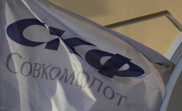 A flag depicting the logo of the Russian state-owned shipping co<em></em>nglomerate Sovcomflot flies outside the company's hearquarters in St. Petersburg