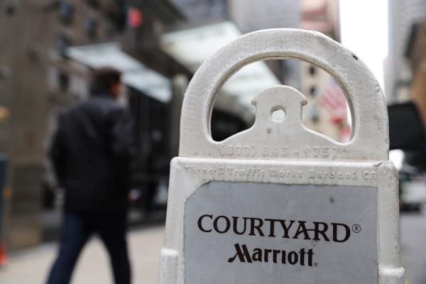 A person passes a Courtyard Marriott hotel in Manhattan, New York City