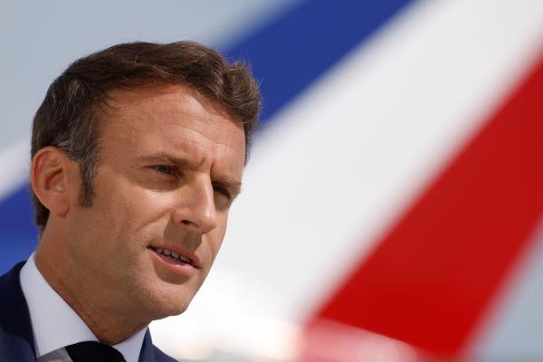 French President Macron delivers a statement at Orly airport before his departure to Romania