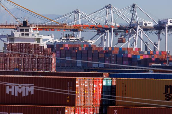 Stacked co<em></em>ntainers are shown as ships unload their cargo at the Port of Los Angeles