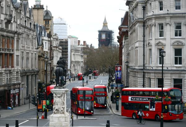 Lo<em></em>ndon buses travel along Whitehall in Westminster in London