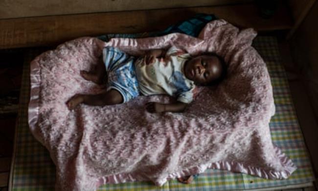 A baby in a crib. 