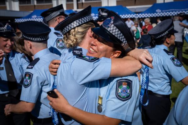 Pace graduates embracing after graduating