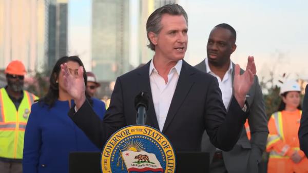 Gov Gavin Newsom at lectern outside