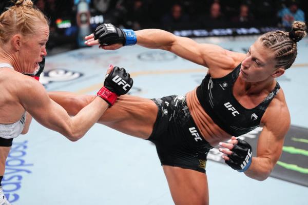 LAS VEGAS, NEVADA - APRIL 13: (R-L) Kayla Harrison kicks Holly Holm in a bantamweight fight during the UFC 300 event at T-Mobile Arena on April 13, 2024 in Las Vegas, Nevada.  (Photo by Jeff Bottari/Zuffa LLC via Getty Images)