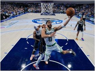 Dallas Mavericks guard Luka Do<em></em>ncic (77) shoots in front of Boston Celtics forward Jayson Tatum (0) during the second half in Game 3 of the NBA basketball finals, Wednesday, June 12, 2024, in Dallas. The Celtics won 106-99. (AP Photo/Julio Cortez, Pool)